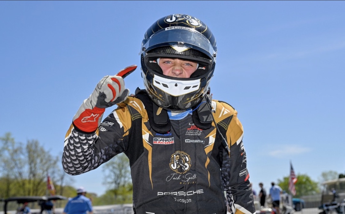 Helmet on — one finger up